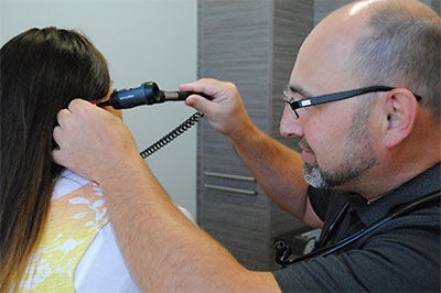 dor Ward expanining patient's ear.