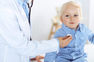 doctor checking child's vitals.