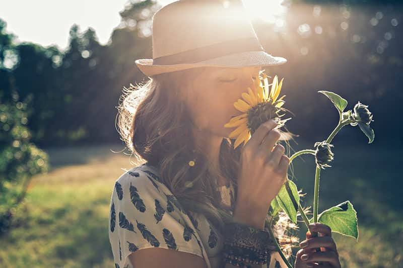 Girl smelling sunflower